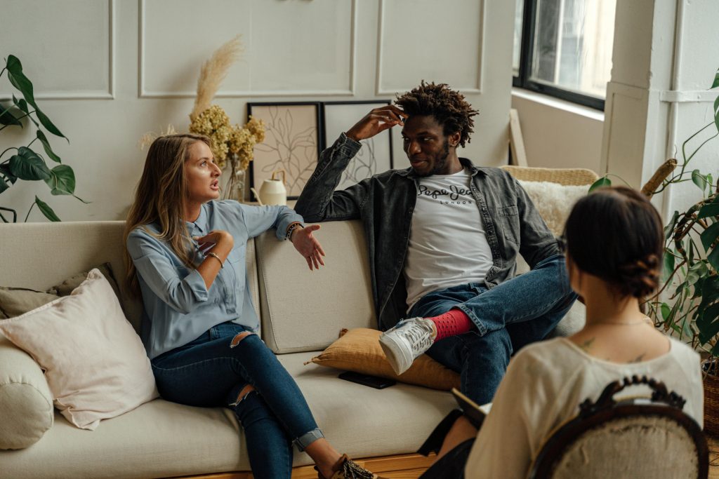 Couple sitting with their therapist during a couples therapy session